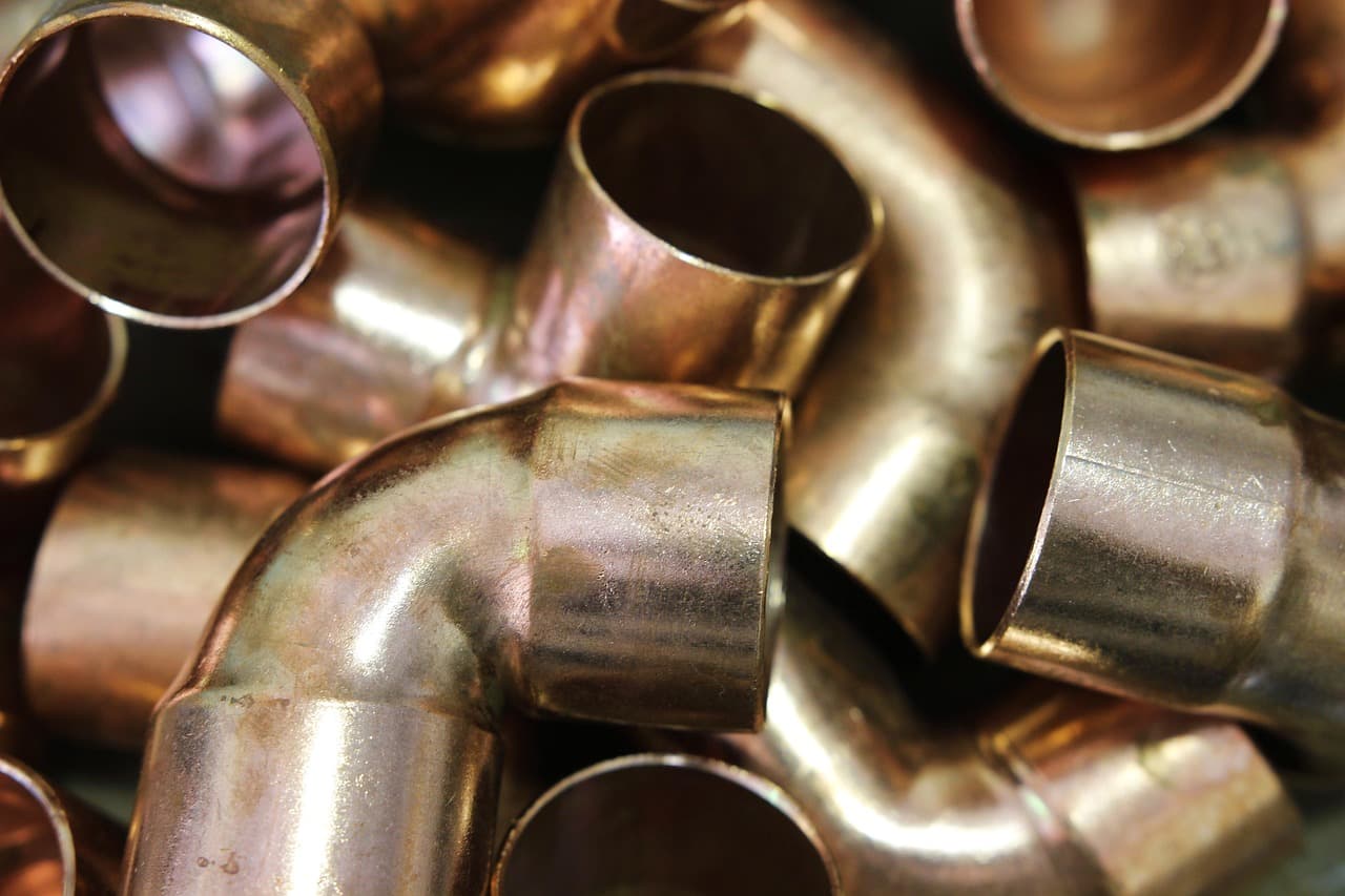 Copper pipe elbows and fittings, warm brass tones