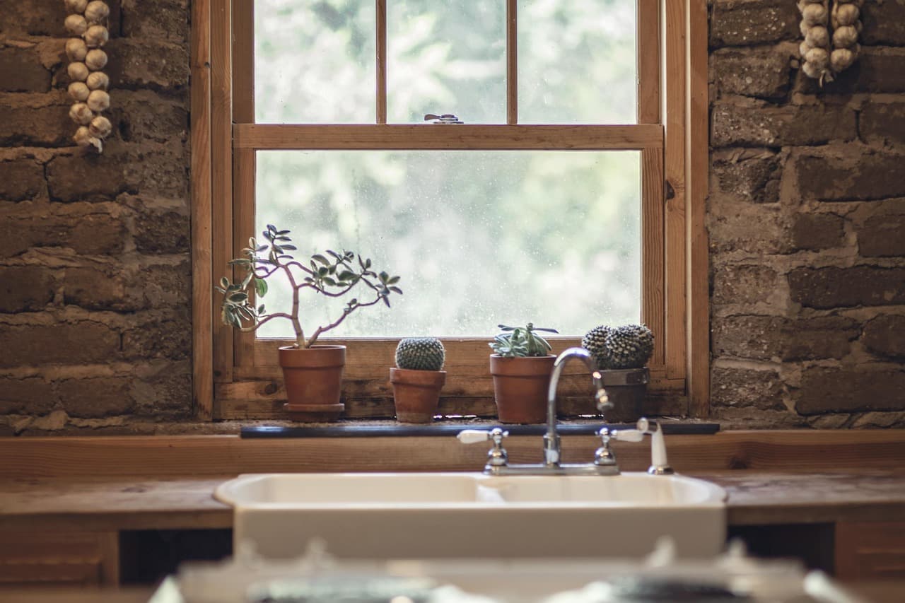A mixer tap over a deep sink under a sash window